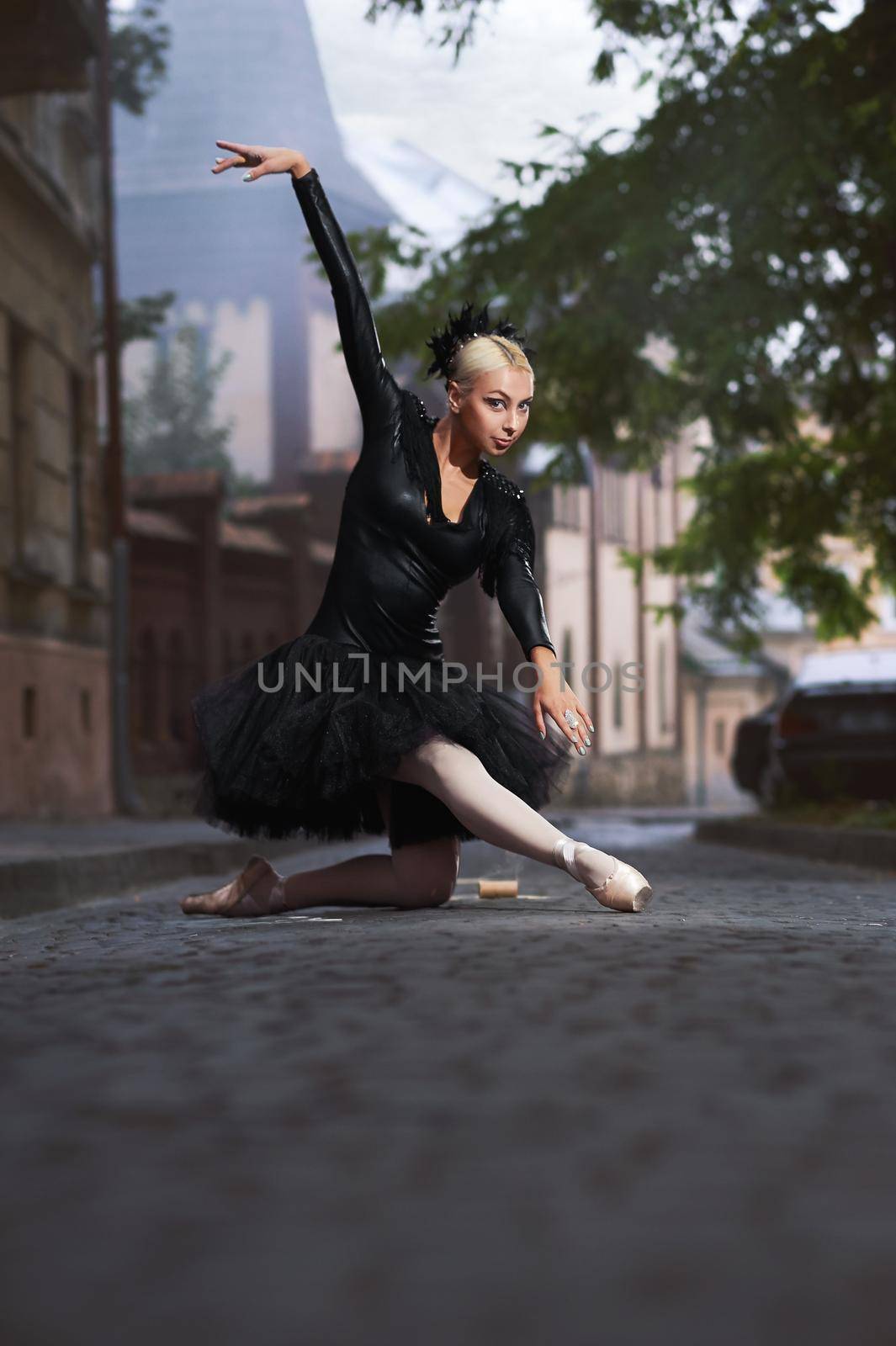 Gorgeous ballerina in black outfit dancing in the city streets by SerhiiBobyk