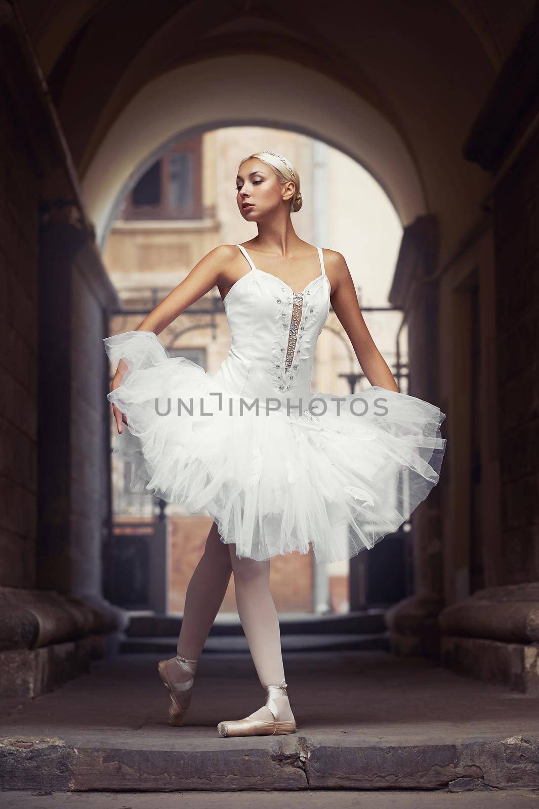 Ballet beauty. Soft focus shot of a gorgeous woman ballet dancer standing in an old archway