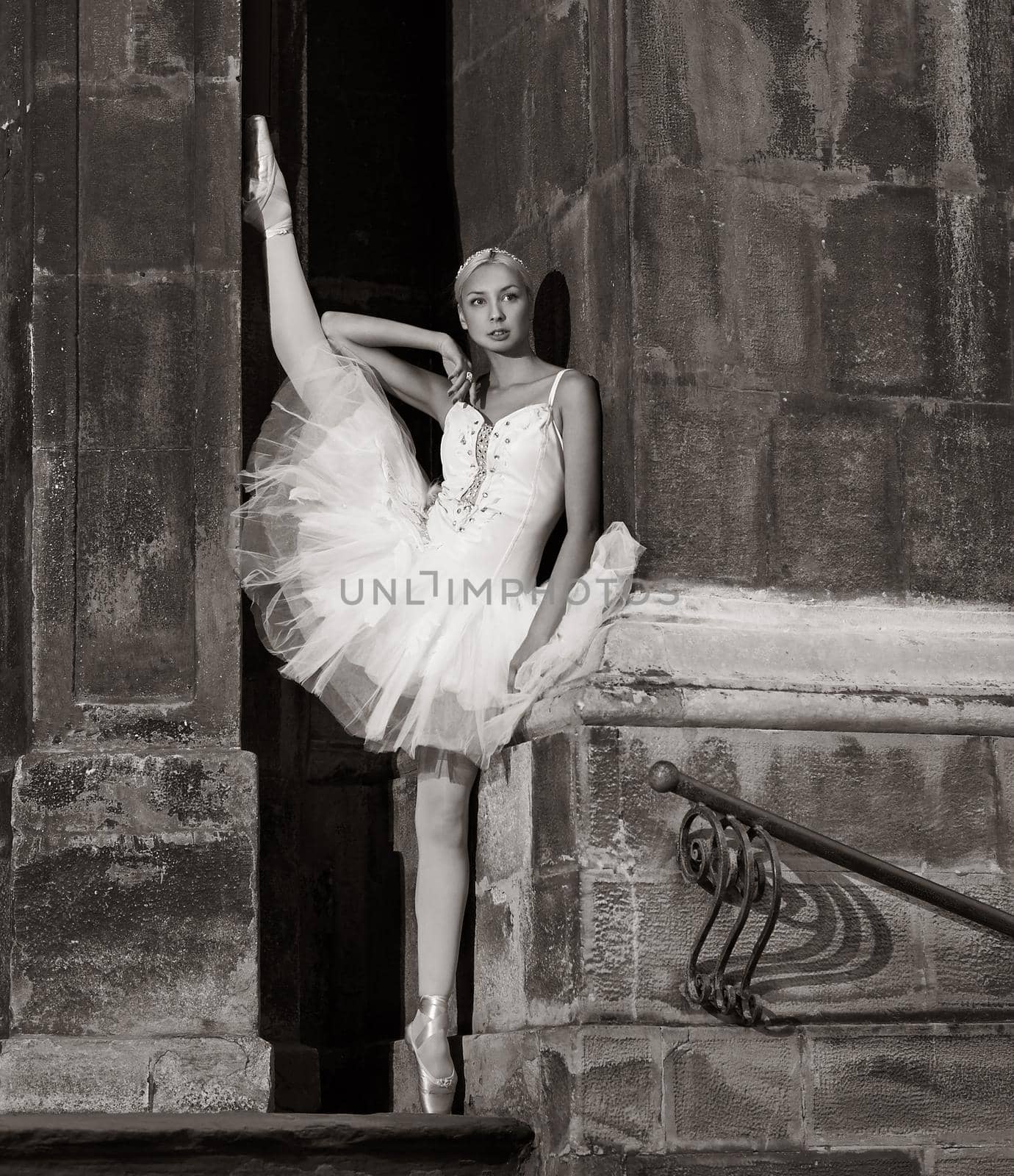 Artistic look. Monochrome portrait of a beautiful ballet dancer posing near the wall looking away thoughtfully soft focus picture
