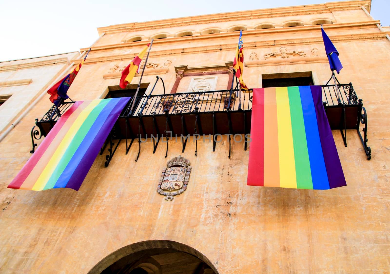 Rainbow flag hanging from the balcony of the town hall for the International Gay Pride Day in Elche, Alicante, Spain.