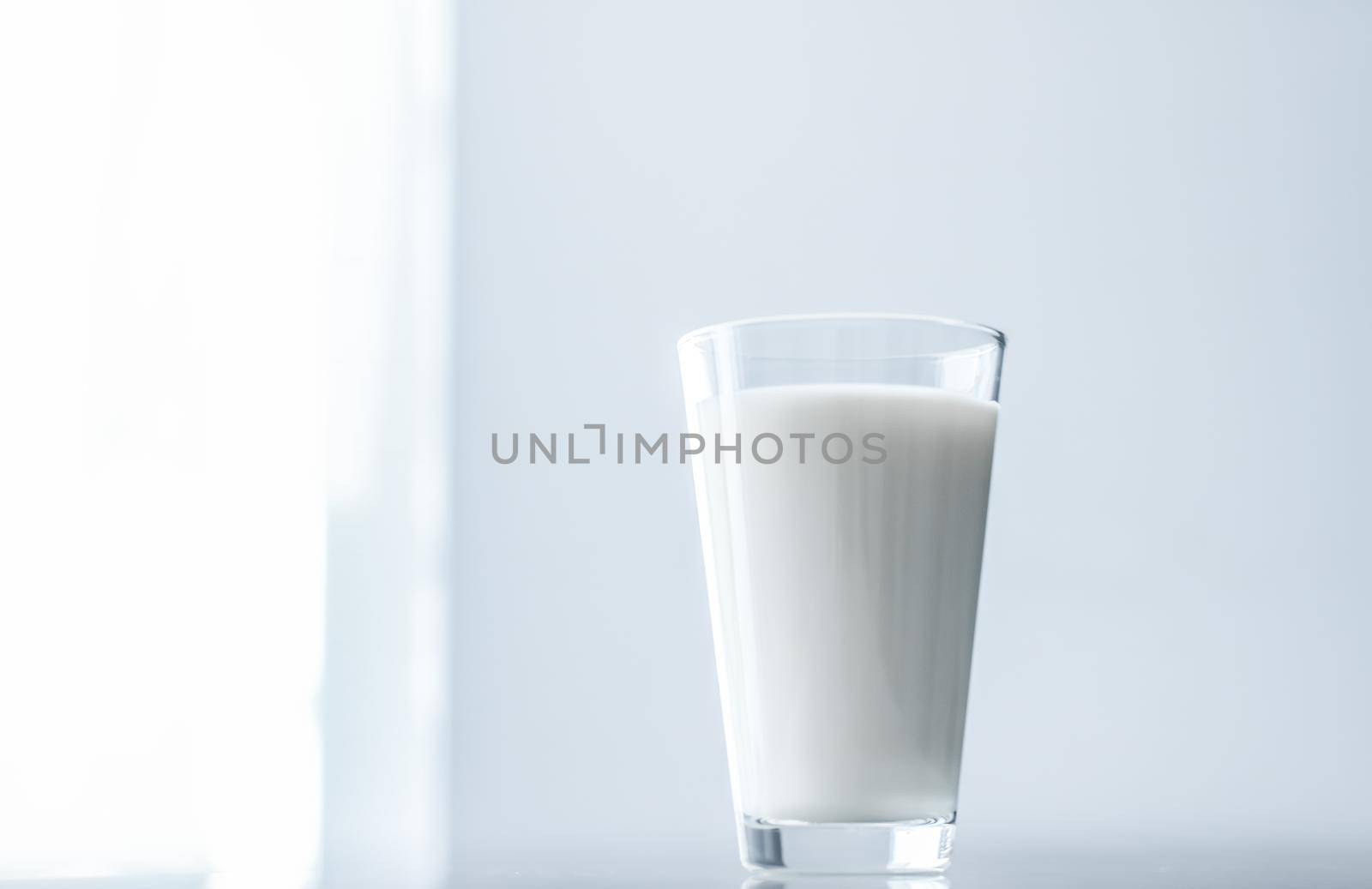 Dairy, healthy nutrition and breakfast concept - World Milk Day, full glass on marble table