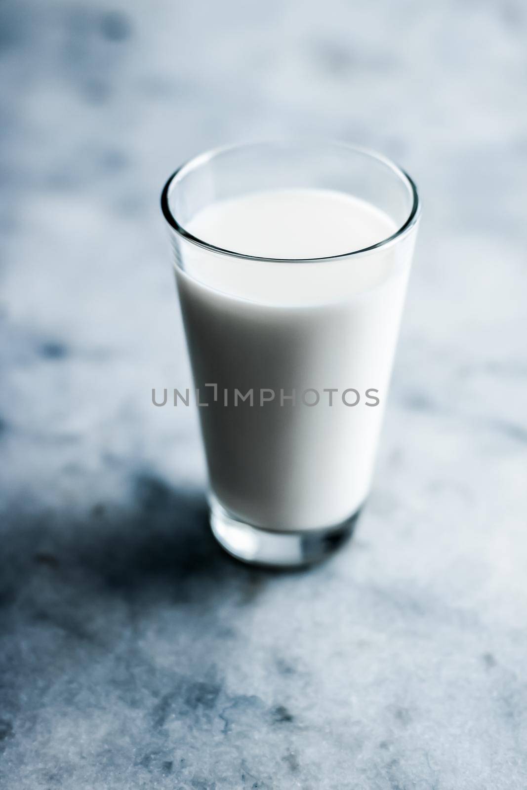 Dairy, healthy nutrition and breakfast concept - World Milk Day, full glass on marble table