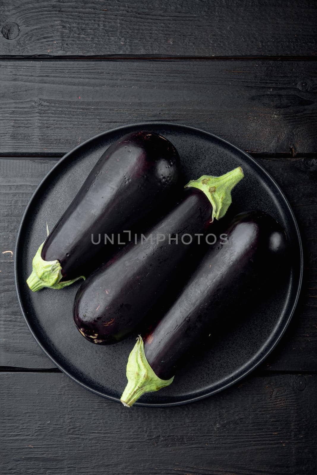 Eggplant, aubergine organic ripe whole vegetables set, on black wooden table background, top view flat lay