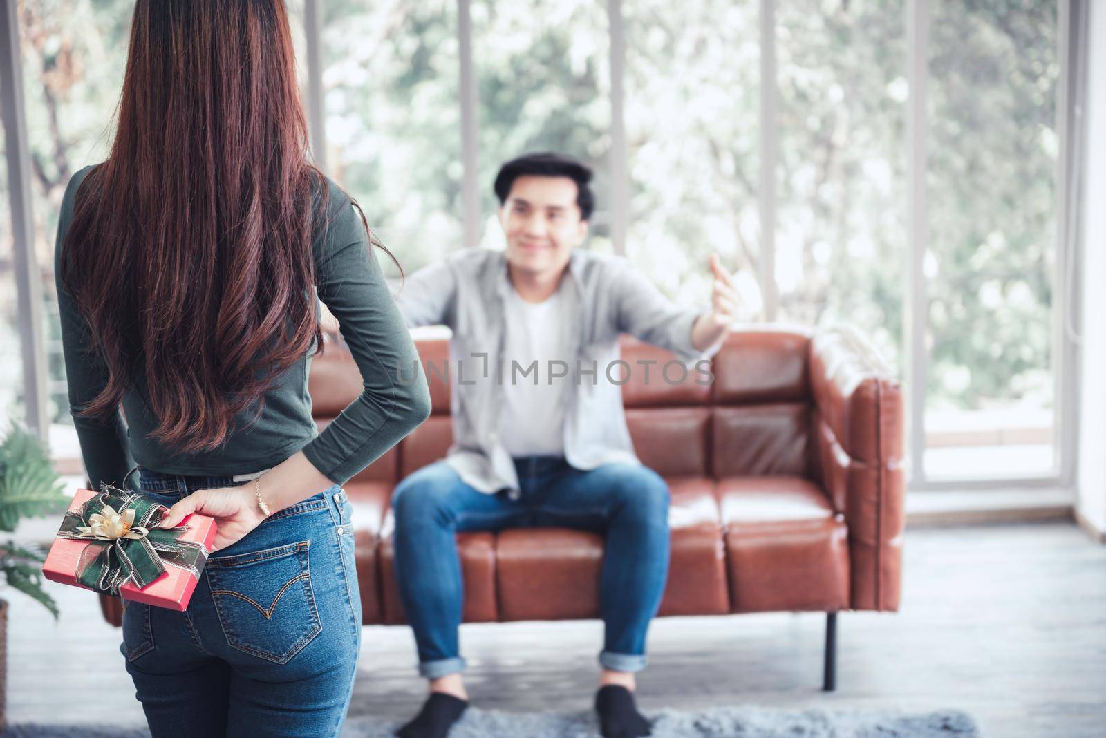 Romantic Couple Love and Valentine Celebration Concept, Young Woman Excited While Presenting Gift to Her Boyfriend in Living Room. Couple Lover Giving Present Gift Box Together in Celebrating Birthday by MahaHeang245789