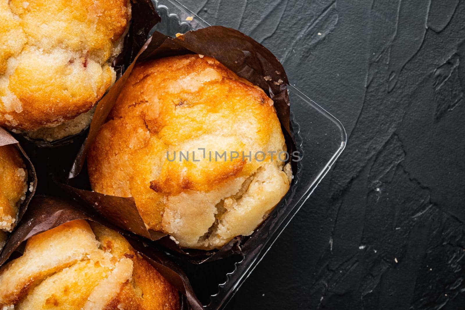 Delicious tasty muffin, on black background, top view flat lay with copy space for text