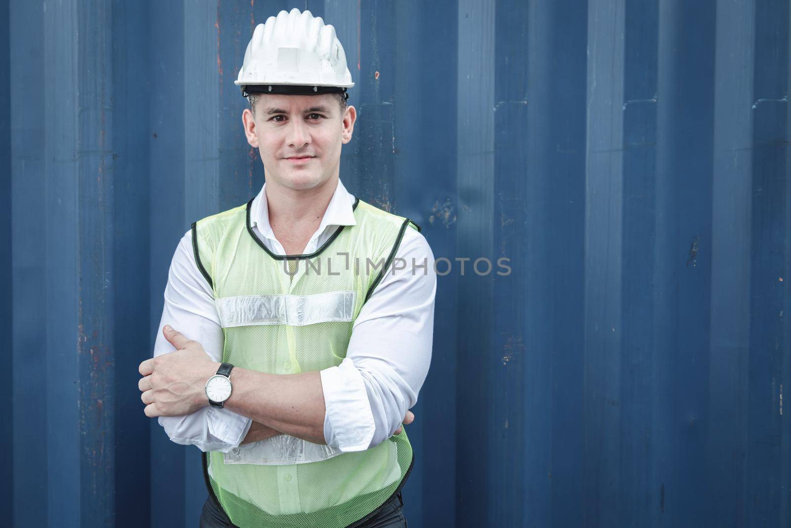 Portrait of Confident Transport Engineer Man in Safety Equipment Standing in Container Ship Yard. Transportation Engineering Management and Containers Logistics Industry, Shipping Worker Occupation by MahaHeang245789