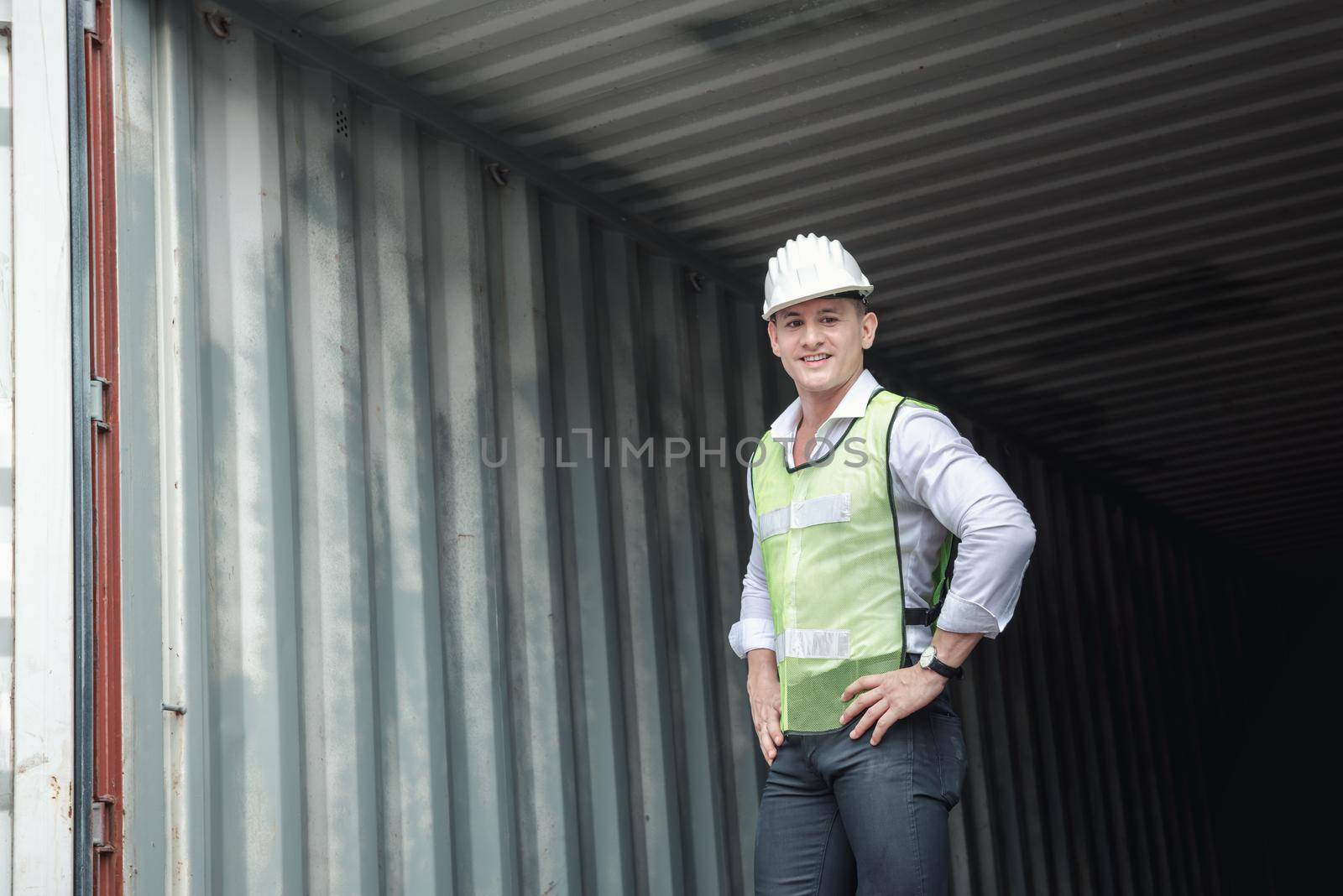 Container Logistics Shipping Management of Transportation Industry, Portrait of Transport Engineer Man Working Control Containers in Ship Yard. Business Cargo Ship Import/Export Factory Logistic.