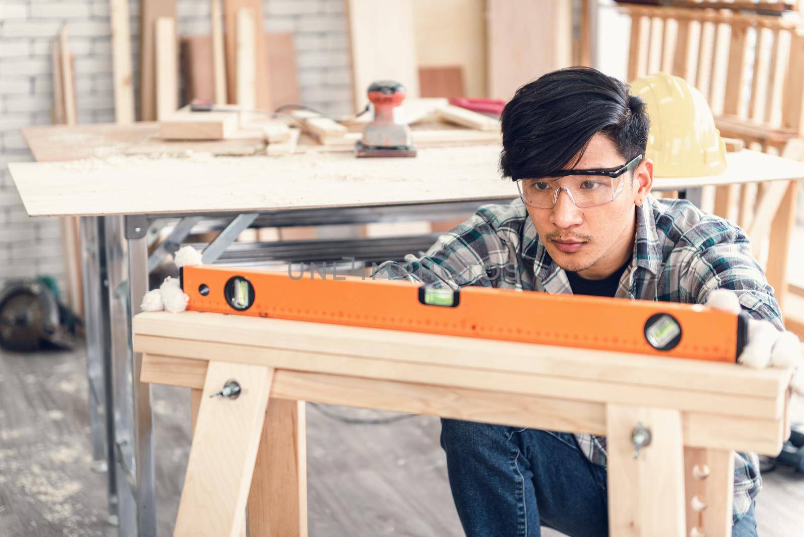 Carpenter Man is Working Timber Woodworking in Carpentry Workshops, Craftsman is Leveling Alignment to Timber Plank for Wooden Furniture in Workshop. DIY Workmanship, Job Carpenters Concept