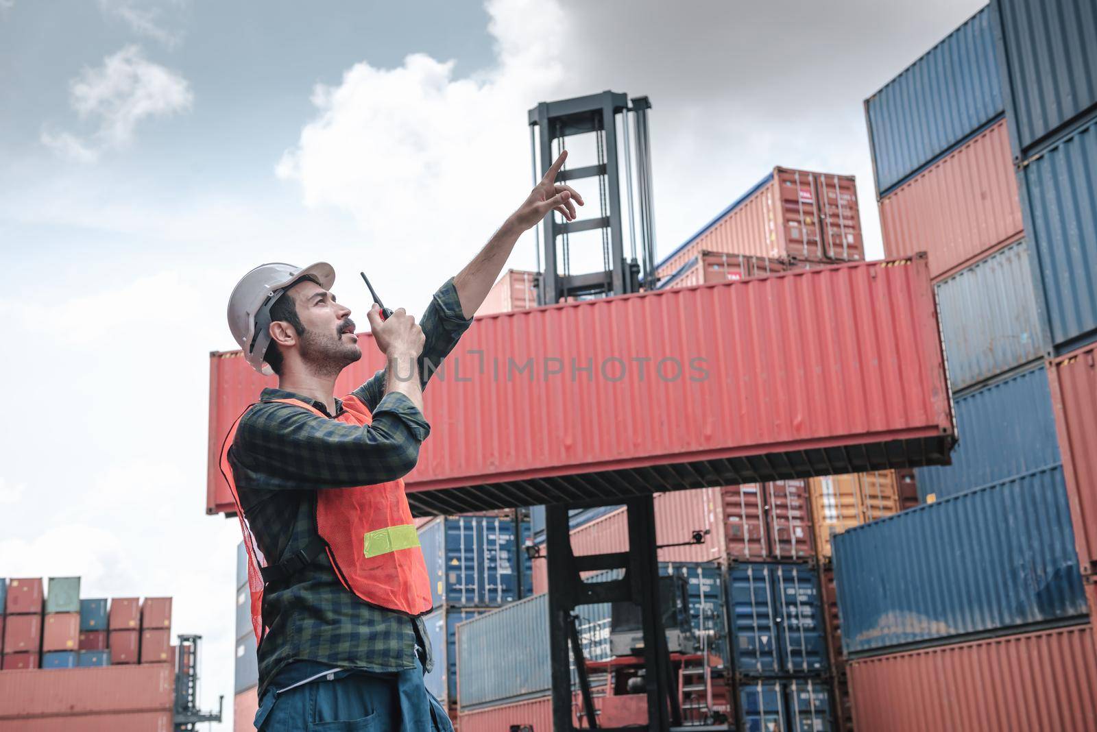 Transport Container Engineer Managing Control Via Walkie Talkie in Containers Shipyard. Container Logistics Shipping Management of Transportation Industry, Business Cargo Ship Import/Export Factory by MahaHeang245789