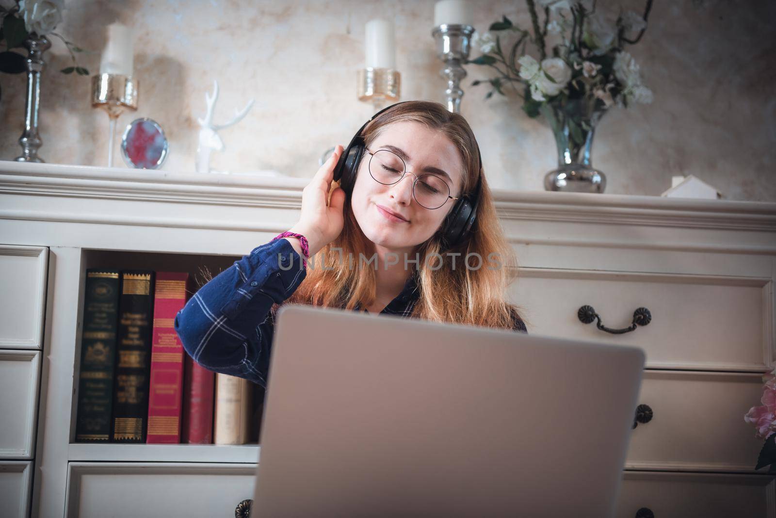 Leisure Activity and Home Relaxing Lifestyle Concept, Attractive Woman Having Enjoyment While Listening Music Songs Via Headphone on Laptop in Living Room. Relaxation Pursuit Entertainment at Home by MahaHeang245789