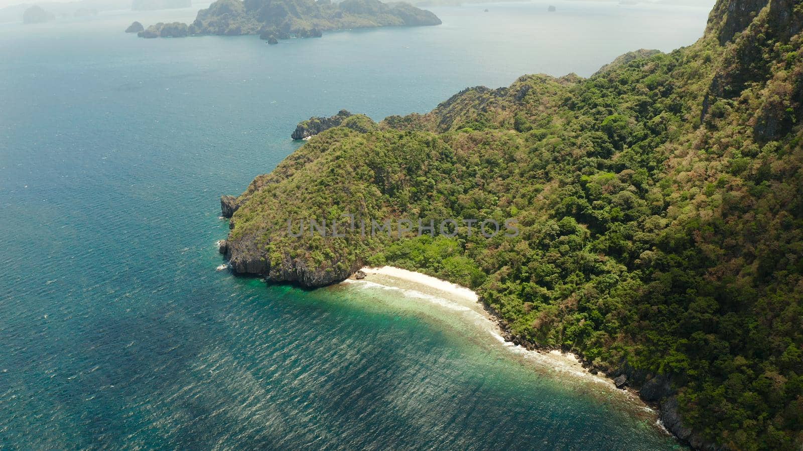 Aerial aerial view wild sandy beach on tropical island with palm trees. El nido, Philippines, Palawan. Tropical landscape with blue lagoon