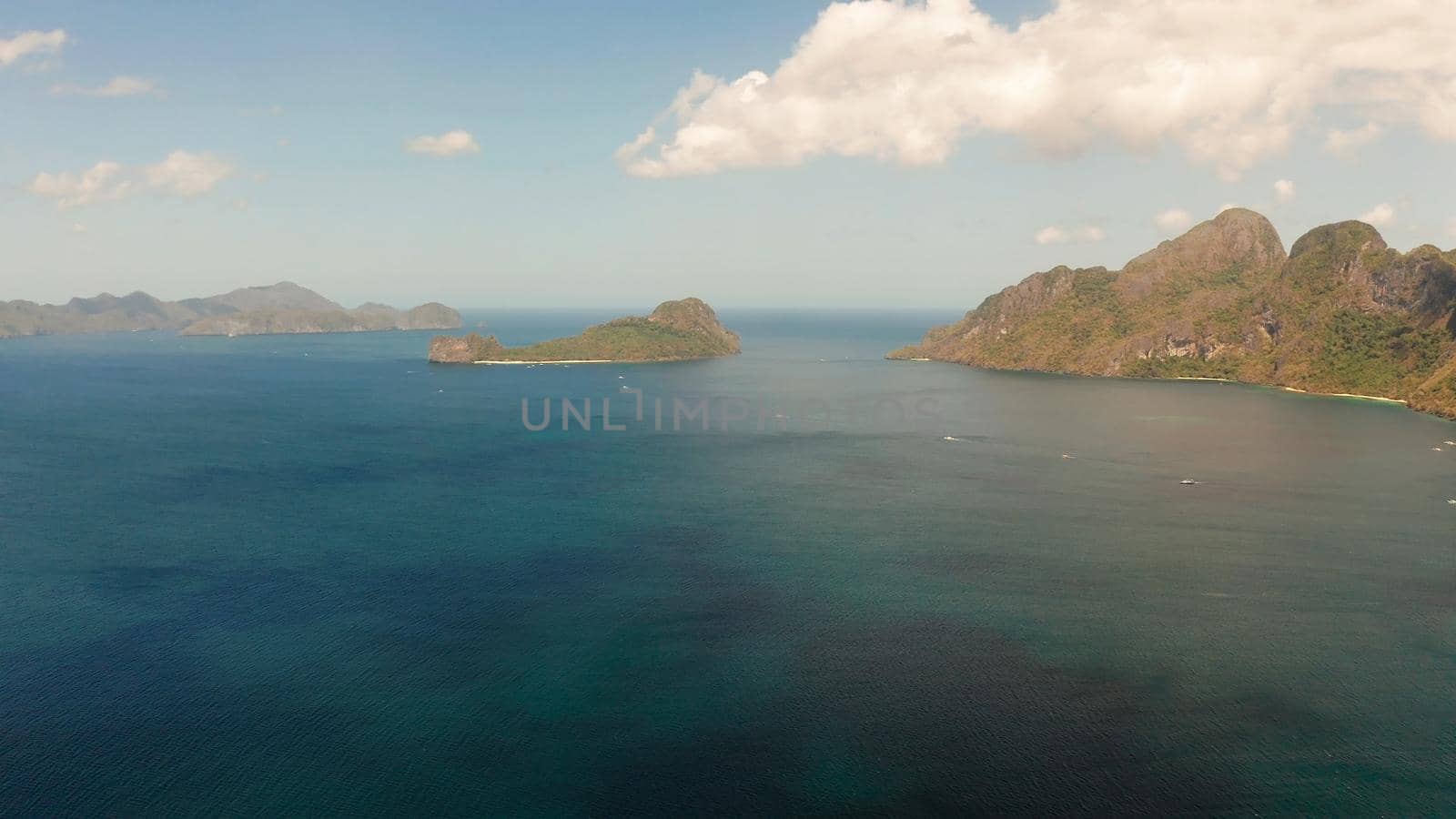 Bay and the tropical islands. Seascape with tropical rocky islands, ocean blue wate, aerial view. islands and mountains covered with tropical forest. El nido, Philippines, Palawan. Tropical Mountain Range