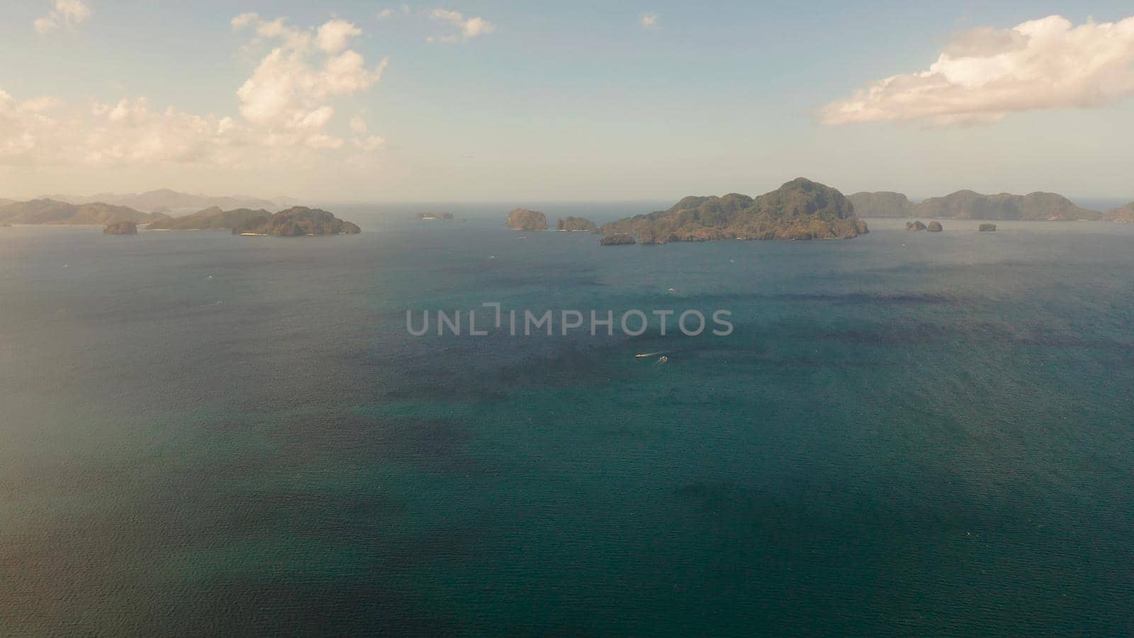 Seascape with tropical rocky islands, ocean blue water, aerial view . islands and mountains covered with tropical forest. El nido, Philippines, Palawan. Tropical Mountain Range