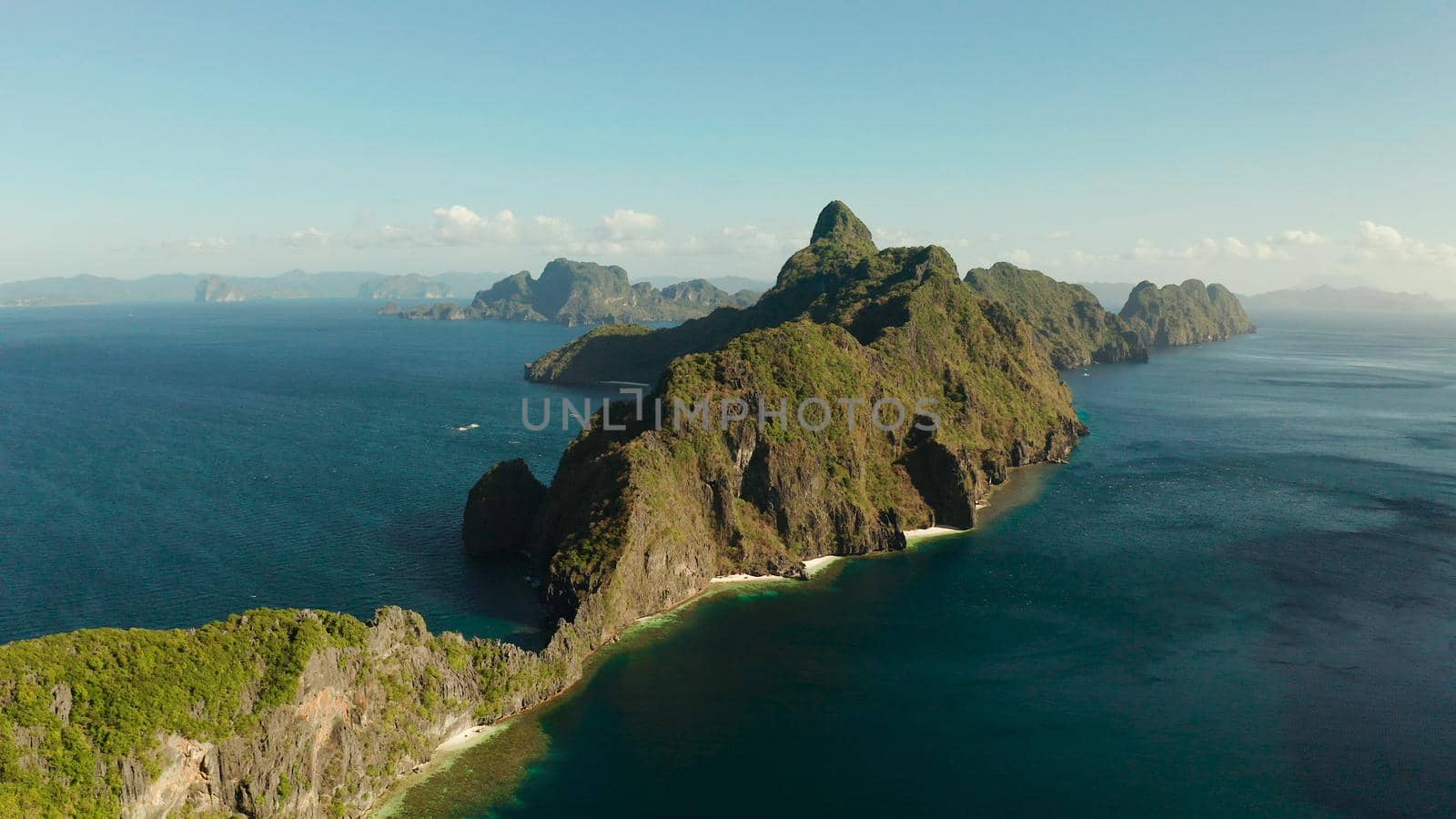 Bay and the tropical islands. Seascape with tropical rocky islands, ocean blue wate, aerial view. islands and mountains covered with tropical forest. El nido, Philippines, Palawan. Tropical Mountain Range