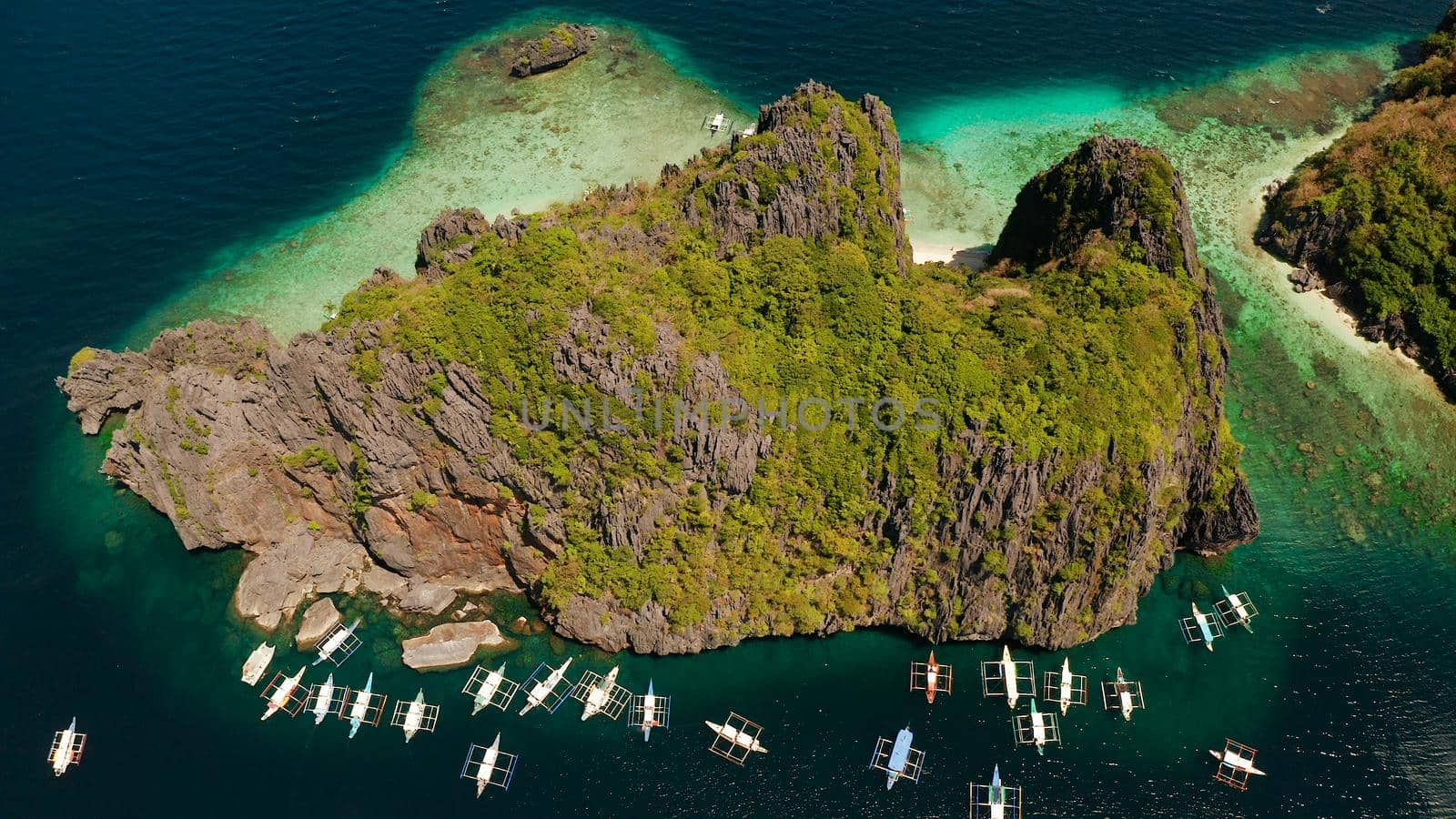 Tourist boats over tropical lagoon and coral reef, aerial view. El nido, Philippines, Palawan. Summer and travel vacation concept.