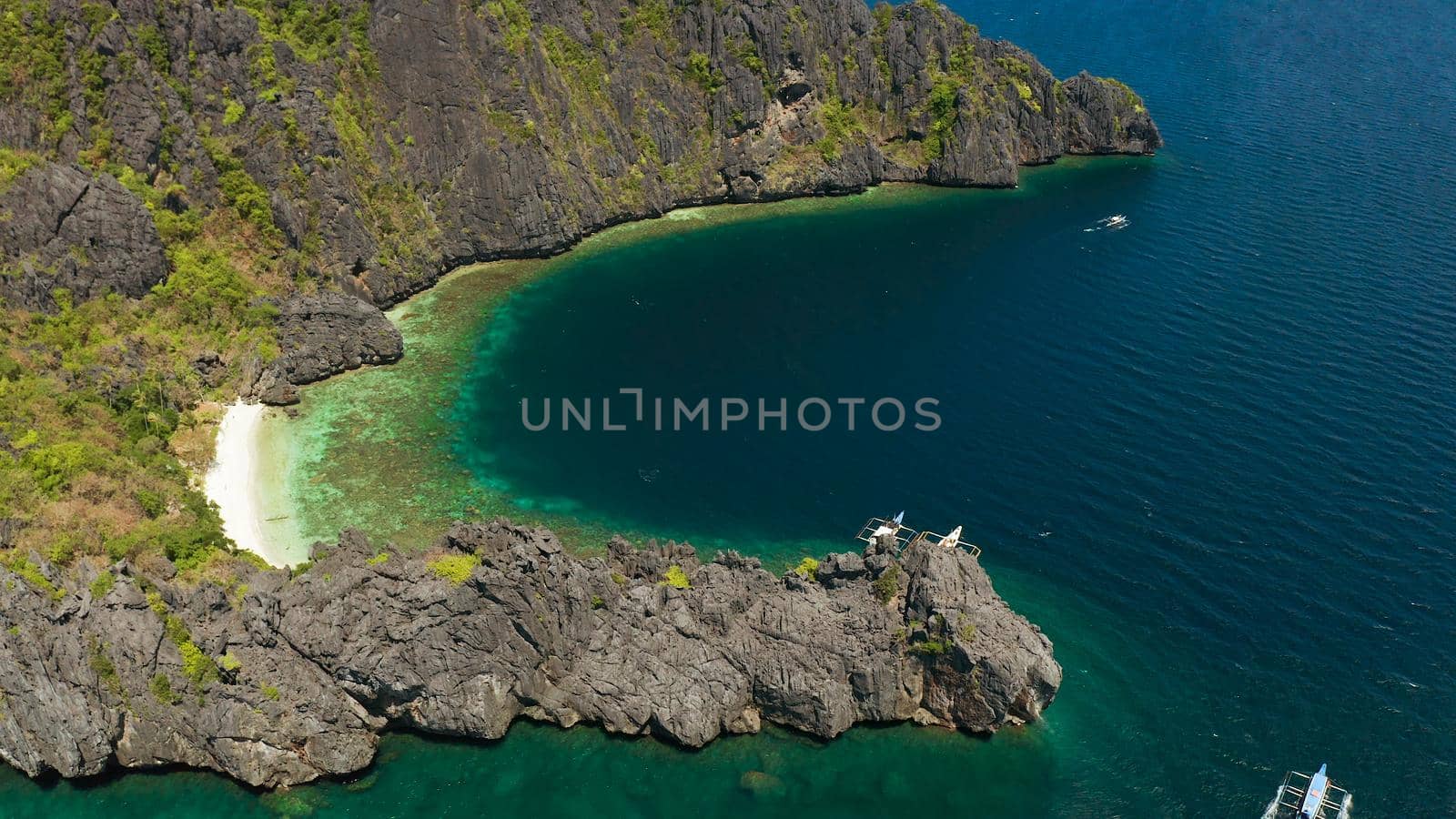 aerial view tropical lagoon with sandy beach surrounded by cliffs. El nido, Philippines, Palawan. beautiful lagoon and karst scenery.
