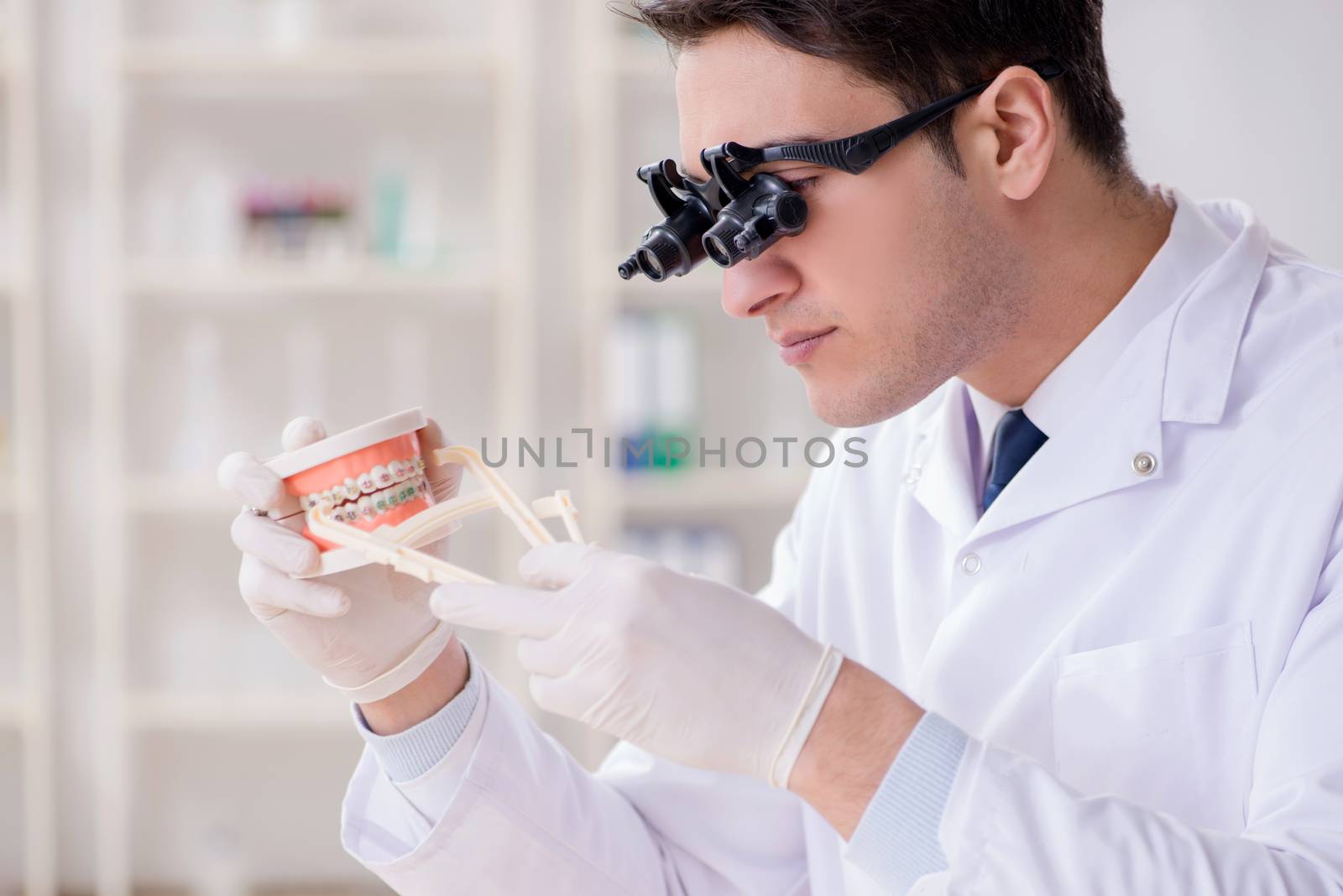Young dentist working in the dentistry hospital by Elnur