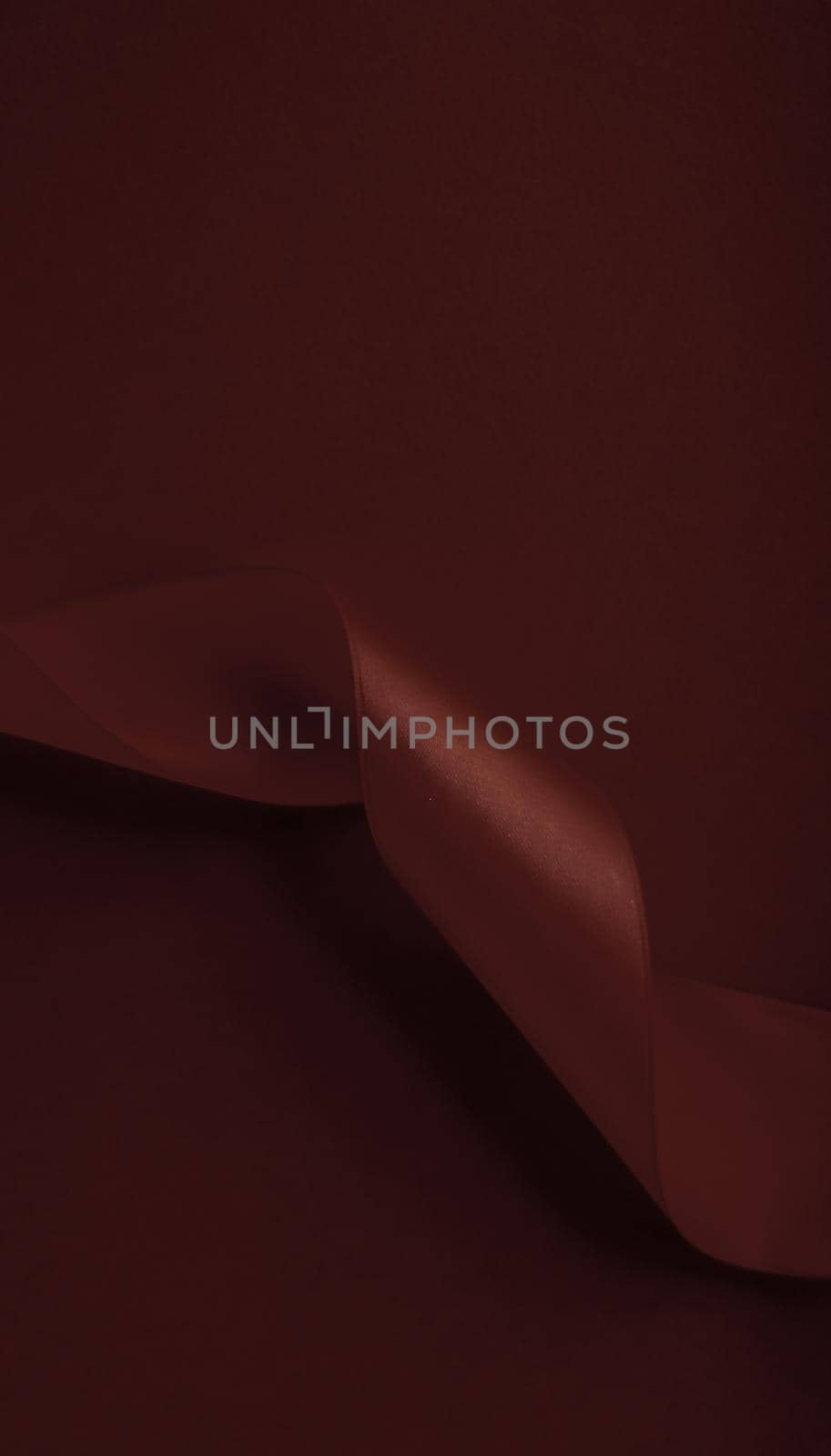 Branding, holidays and luxe brands concept - Abstract silk ribbon on chocolate background, exclusive luxury brand design for holiday sale product promotion and glamour art invitation card backdrop