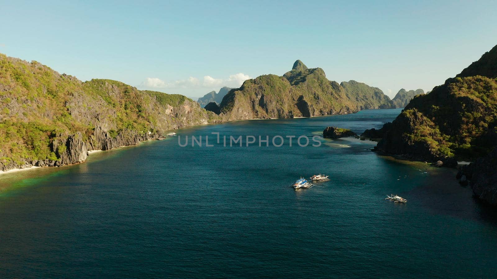 Bay and the tropical islands. Seascape with tropical rocky islands, ocean blue wate, aerial view. islands and mountains covered with tropical forest. El nido, Philippines, Palawan. Tropical Mountain Range