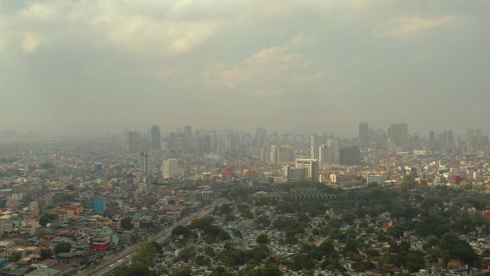 Manila North Cemetery and Cityscape of Makati, the business center of Manila, view from above. Asian metropolis. Travel vacation concept.