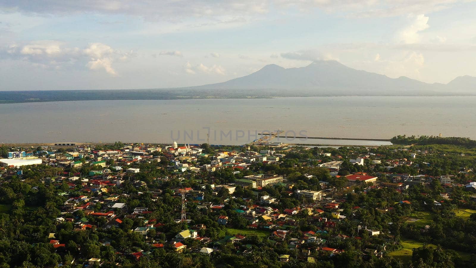 Sorsogon City, Luzon, Philippines. Town by the sea, top view. Landscape in Asia. Summer and travel vacation concept. View of a small town and a volcano in the distance.