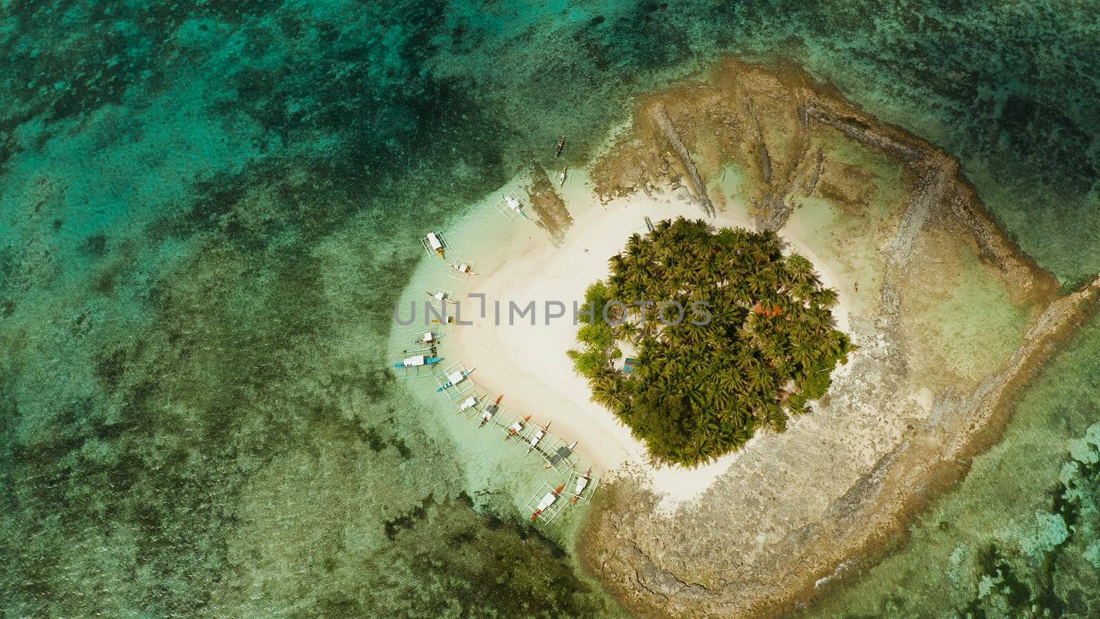 Travel concept: sandy beach on a small island by coral reef atoll from above. Guyam island, Philippines, Siargao. Summer and travel vacation concept.