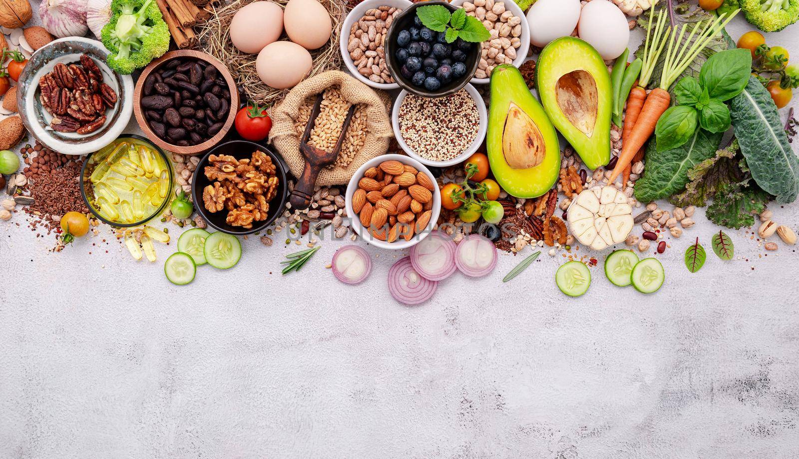 Ingredients for the healthy foods selection. The concept of superfoods set up on white shabby concrete background with copy space.