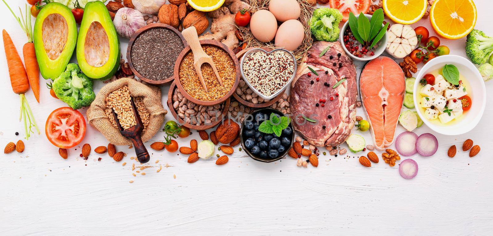 Ketogenic low carbs diet concept. Ingredients for healthy foods selection set up on white wooden background. by kerdkanno