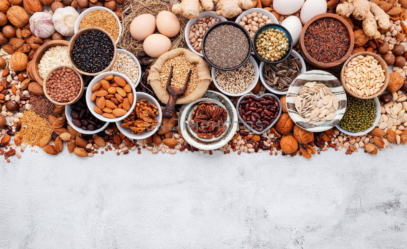 Ingredients for the healthy foods selection. The concept of superfoods set up on white shabby concrete background with copy space.