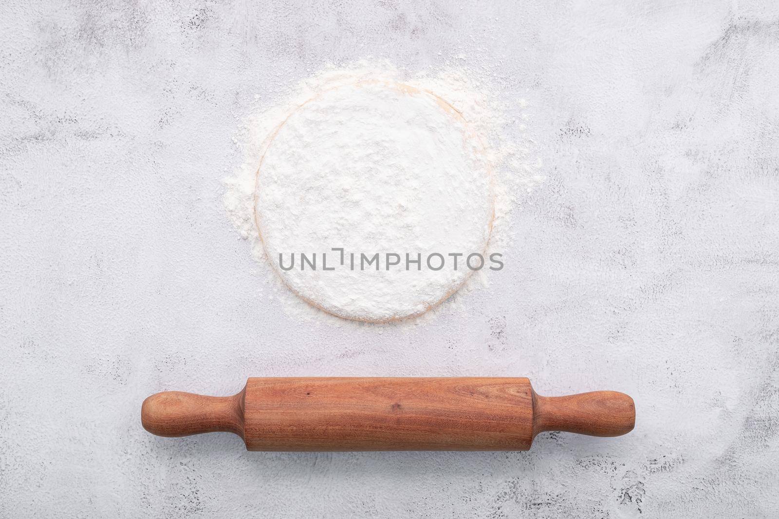 Fresh homemade yeast dough resting on whote concreate background flat lay with rolling pin.