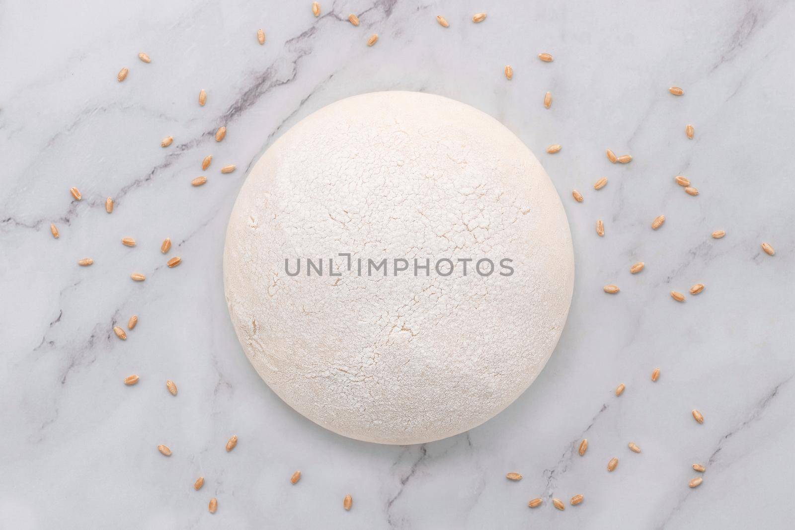 Fresh raw homemade yeast dough resting on marble table flat lay. by kerdkanno