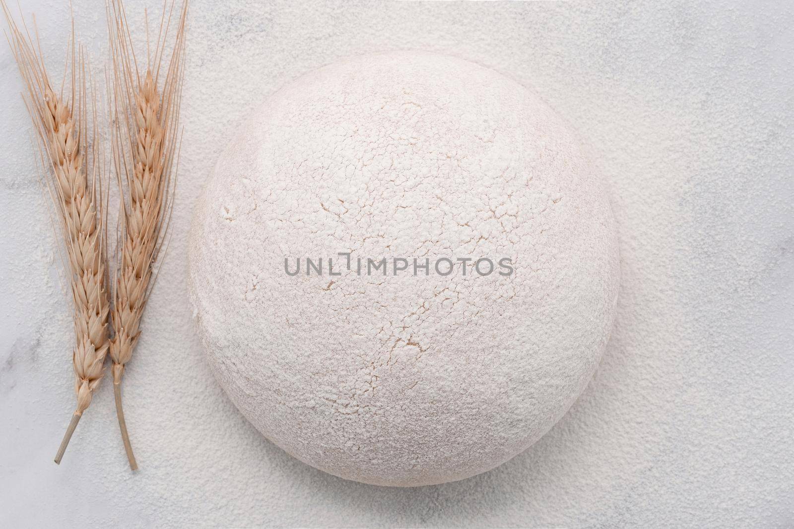 Fresh raw homemade yeast dough resting on marble table flat lay. by kerdkanno