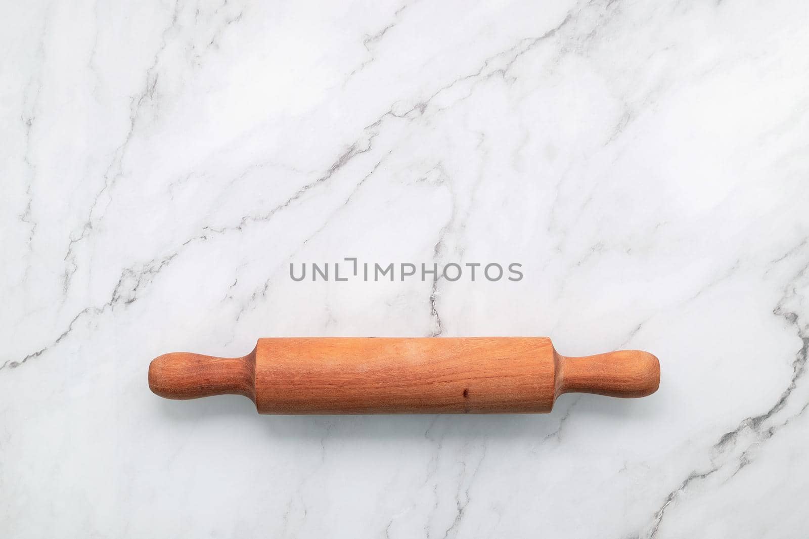 The rolling pin set up on white marble background. Baking background with the rolling with flat lay and free space for text.