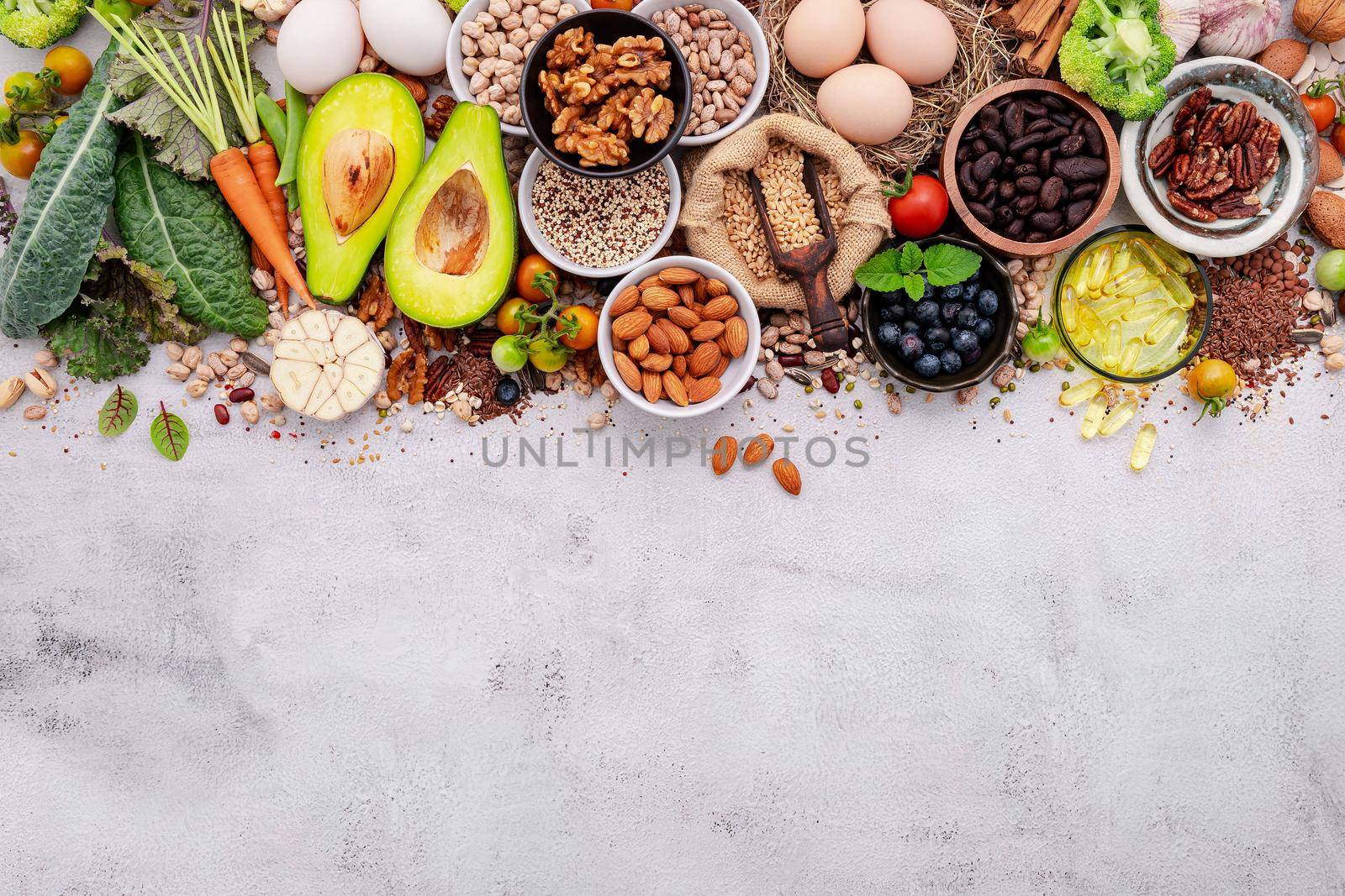 Ingredients for the healthy foods selection. The concept of superfoods set up on white shabby concrete background with copy space. by kerdkanno