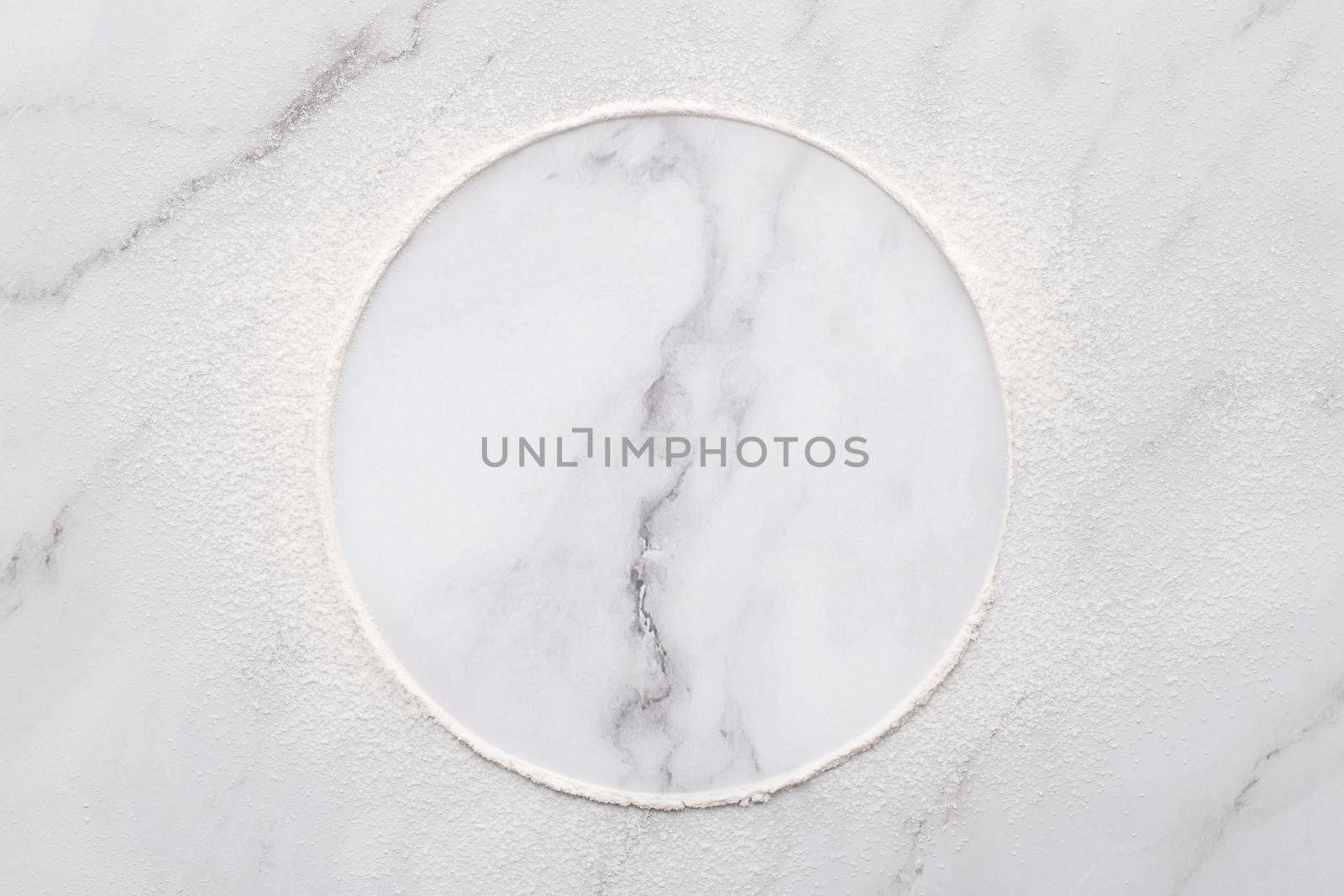 Scattered wheat flour on white marble background. Sprinkled wheat flour circle on white background.