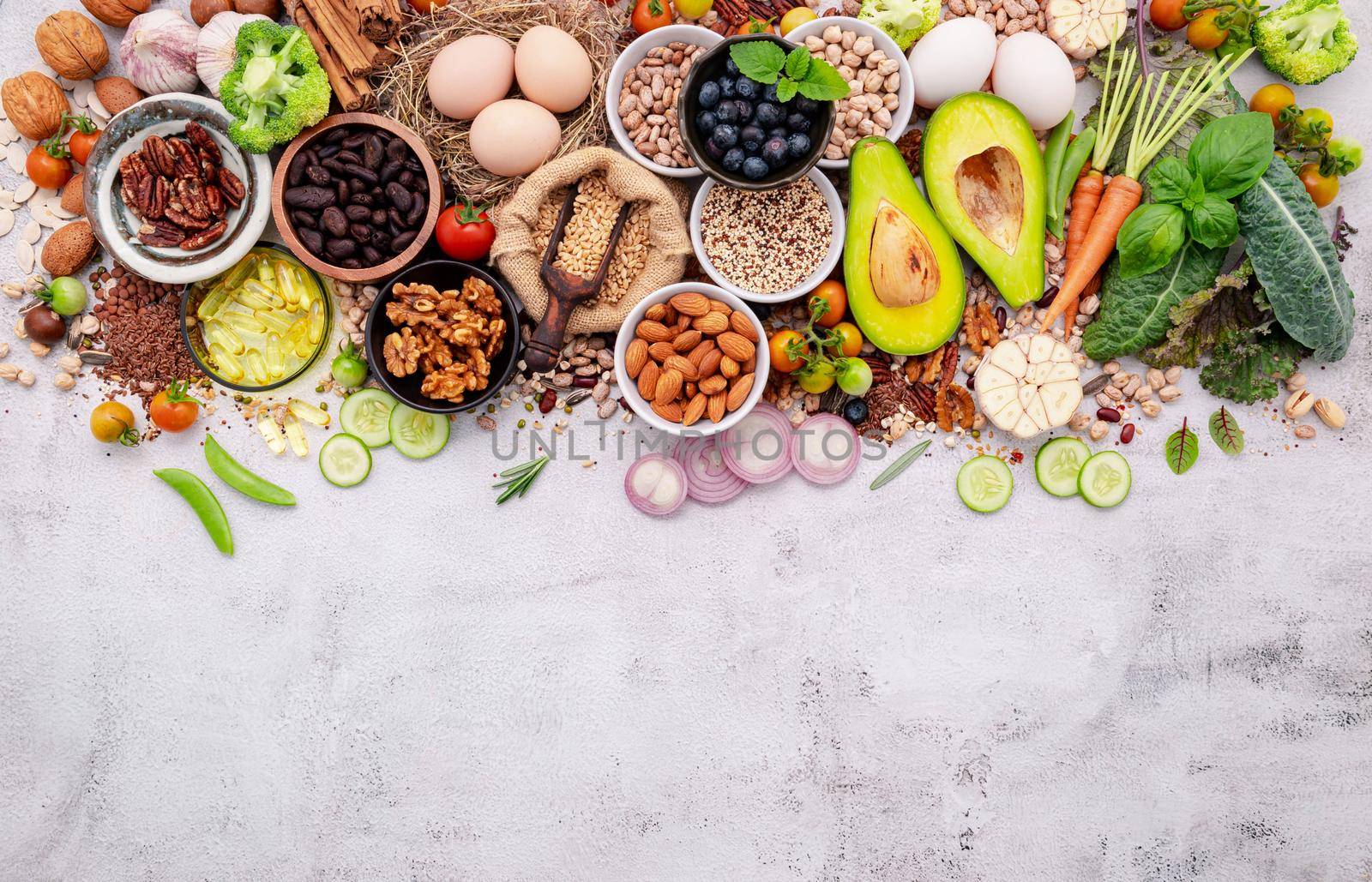 Ingredients for the healthy foods selection. The concept of superfoods set up on white shabby concrete background with copy space.