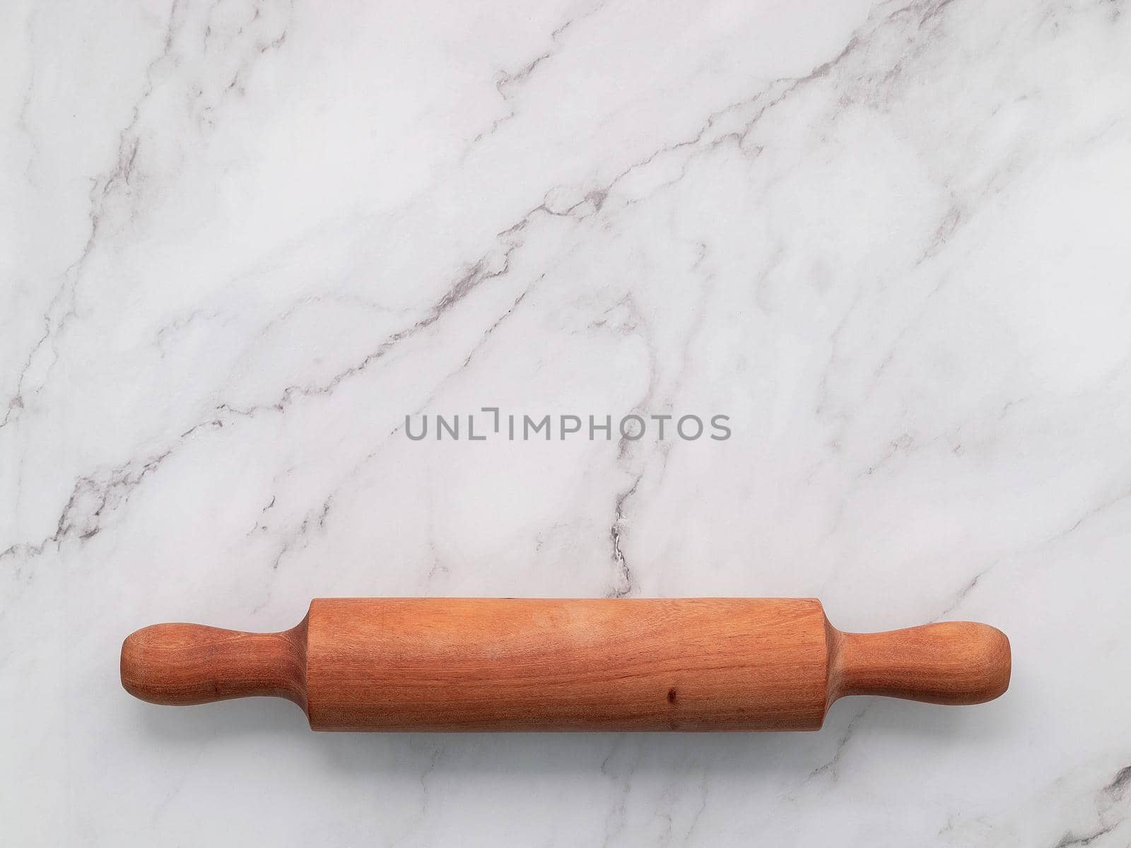 The rolling pin set up on white marble background. Baking background with the rolling with flat lay and free space for text.  by kerdkanno