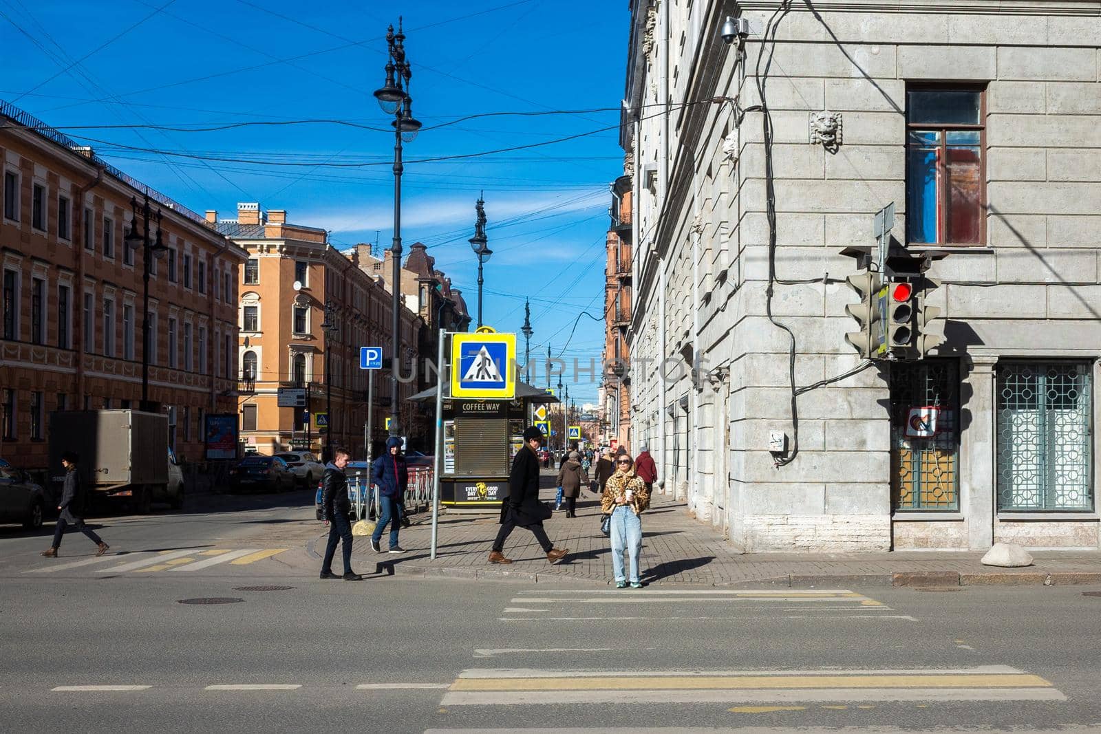 March 30, 2019 St. Petersburg, Russia. Passers-by wait for a permitting traffic light at a pedestrian crossing at a busy intersection in the city center.