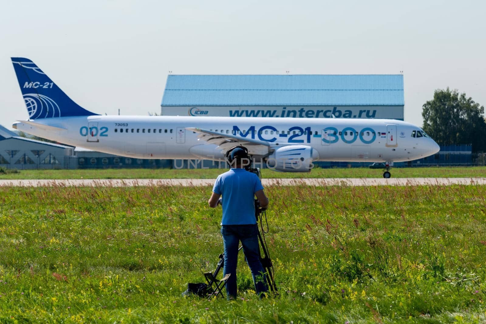 August 30, 2019. Zhukovsky, Russia. The cameraman is filming promising Russian medium-range narrow-body passenger aircraft Irkut MC-21 at the International Aviation and Space Salon MAKS 2019.