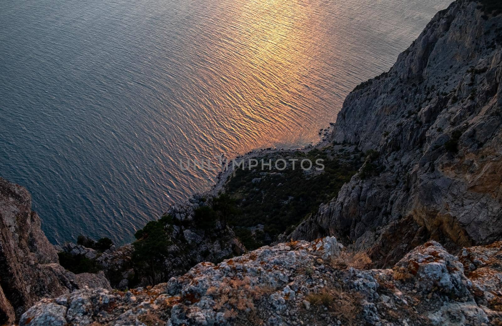 Mediterranean landscape. Forested rocks of the Black Sea coast of the southern coast of the Crimean peninsula at sunset.