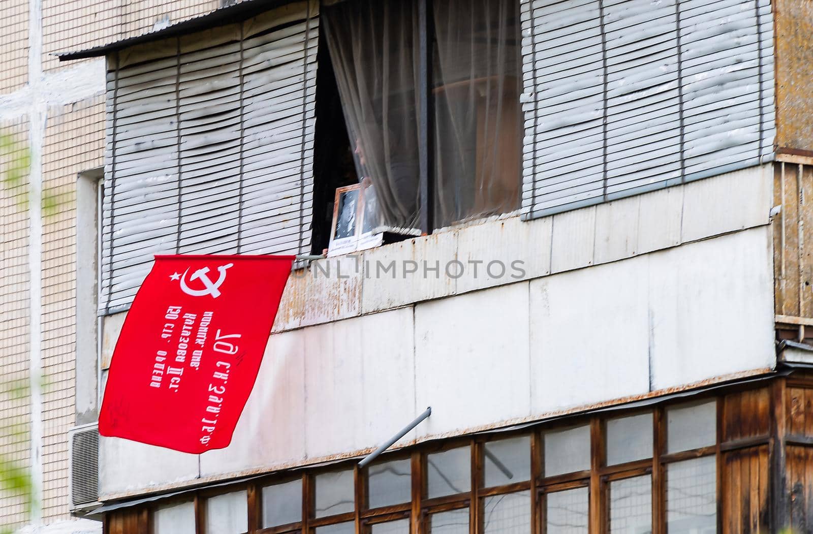 May 9, 2020, Moscow, Russia. Participant of The «Victory Windows" campaign on the balcony of her home.