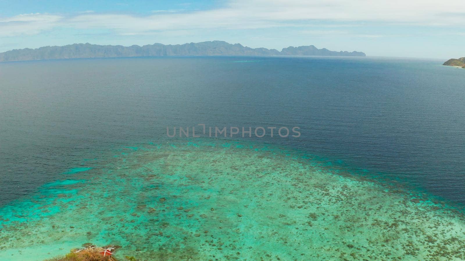 aerial view tropical island with sand white beach. Bulog Dos, Philippines, Palawan. Seascape bay with turquoise water and coral reef.