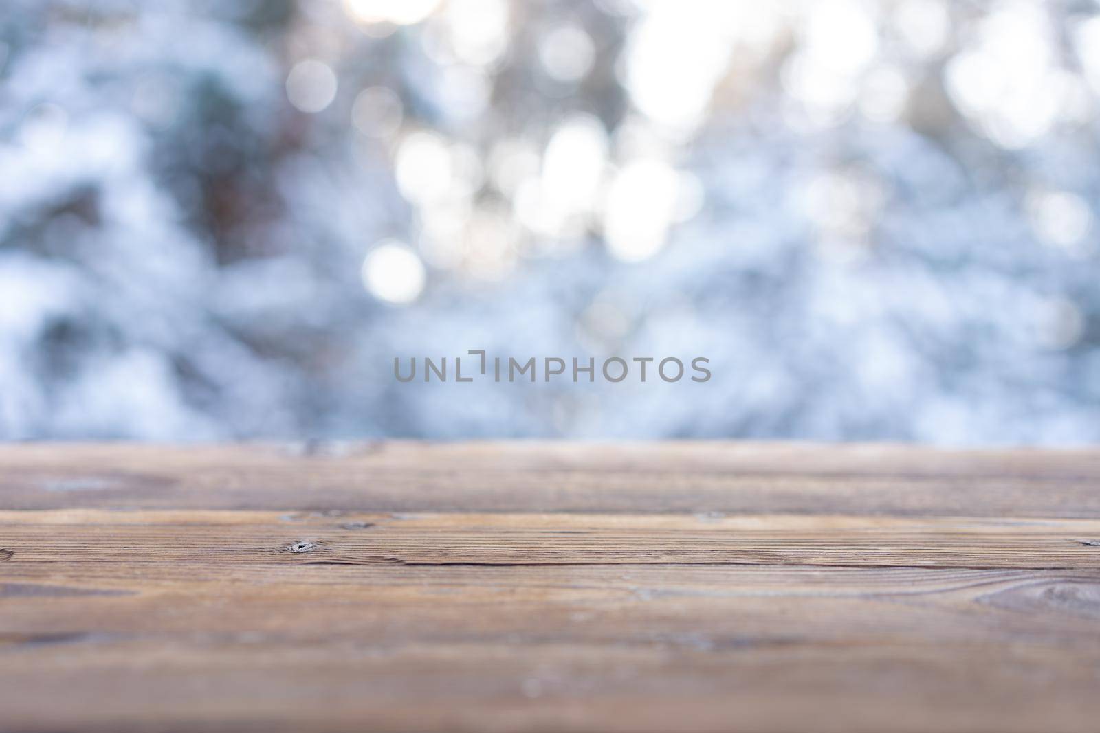 Beautiful winter scene. blurred background of snowy christmas nature background, Wood table top on shiny bokeh. For product display Christmas time mock up . by andreonegin
