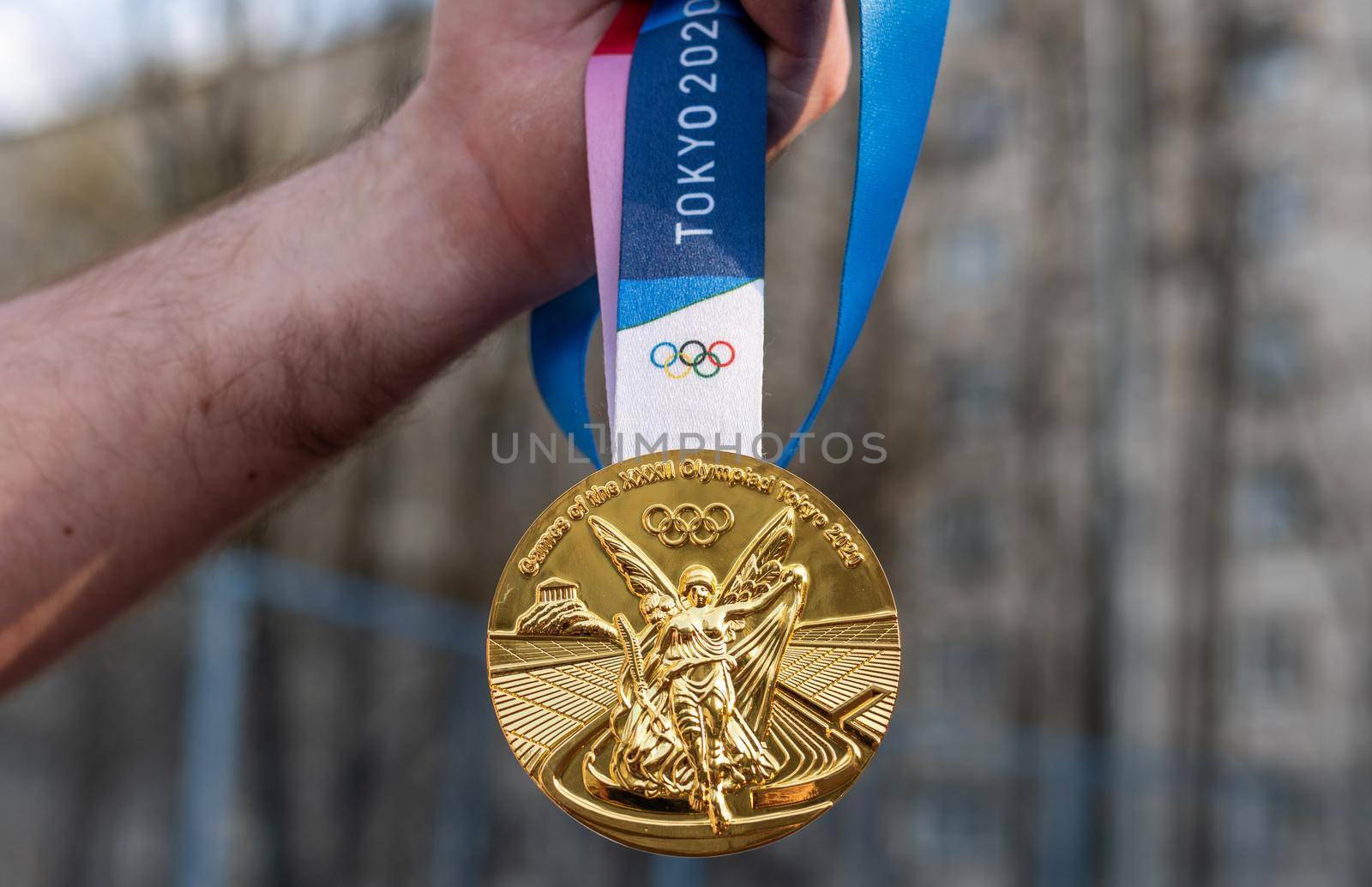 April 17, 2021 Tokyo, Japan. The gold medal of the XXXII Summer Olympic Games in Tokyo in the hand of an athlete.