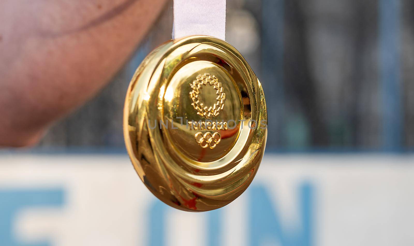 April 17, 2021 Tokyo, Japan. The gold medal of the XXXII Summer Olympic Games in Tokyo in the hand of an athlete.