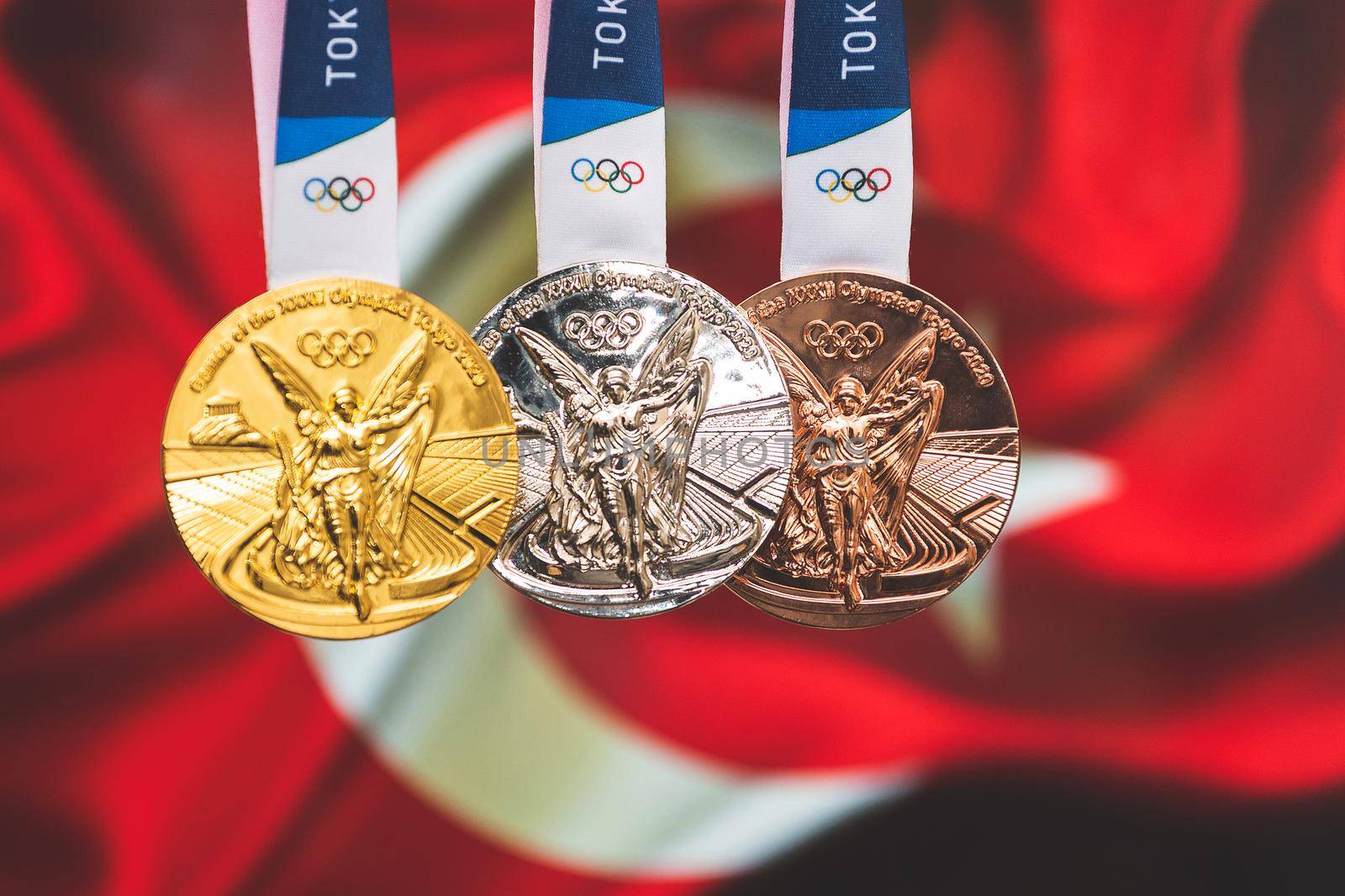 April 25, 2021 Tokyo, Japan. Gold, silver and bronze medals of the XXXII Summer Olympic Games 2020 in Tokyo on the background of the flag of Turkey.
