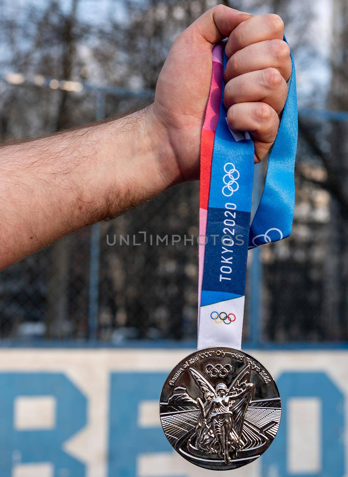 April 17, 2021 Tokyo, Japan. Silver medal of the XXXII Summer Olympic Games in Tokyo in the hand of an athlete.