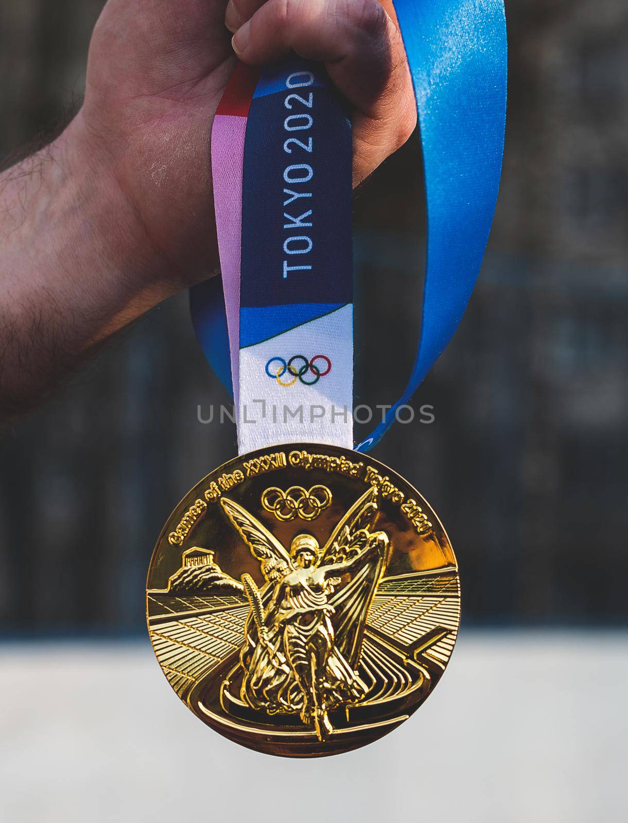 April 17, 2021 Tokyo, Japan. The gold medal of the XXXII Summer Olympic Games in Tokyo in the hand of an athlete.