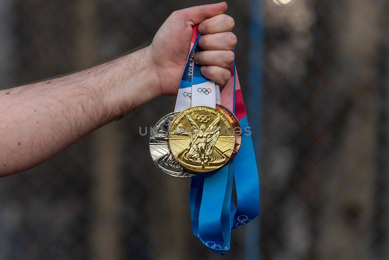 April 17, 2021 Tokyo, Japan. Gold, silver and bronze medals of the XXXII Summer Olympic Games in Tokyo in the hand of an athlete.