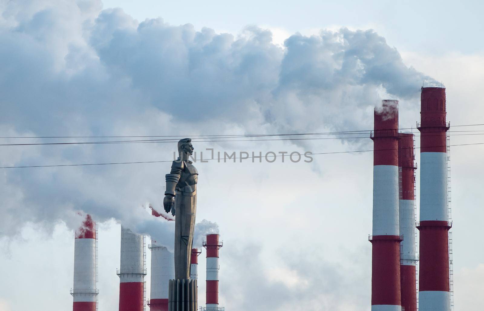 February 7, 2021. Moscow, Russia. Monument to the first cosmonaut was frozen to Yuri Gagarin on Leninsky Prospekt in Moscow against the background of smoke from chimneys.